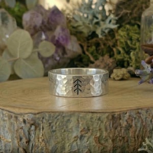 May include: A set of three ceramic mugs with a speckled, matte finish. The mugs are in shades of cream, light gray, and dark gray. Each mug has a simple, minimalist design and a rounded handle.