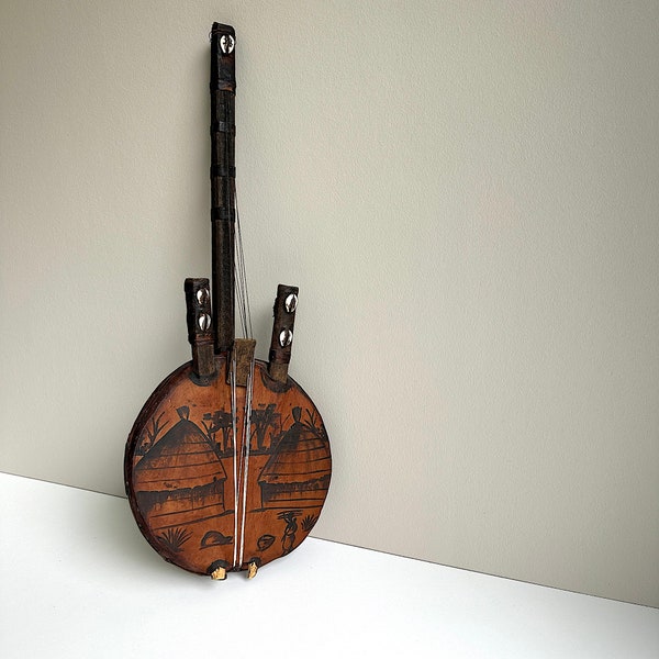 Vintage music instrument. Kora. Bridge harp. Africa. folk art. antique. Handwork . Village scene. Leather. Shellfish