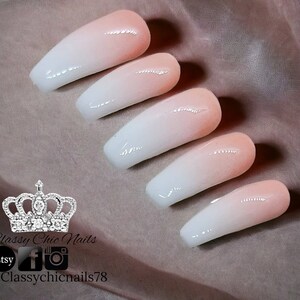 May include: Five press-on nails featuring a smooth ombre gradient transition from a soft peach at the cuticle to a crisp white at the tip. The nails have a glossy finish and a coffin shape. Text includes Classy Chic Nails, Etsy, and @Classychicnails78.