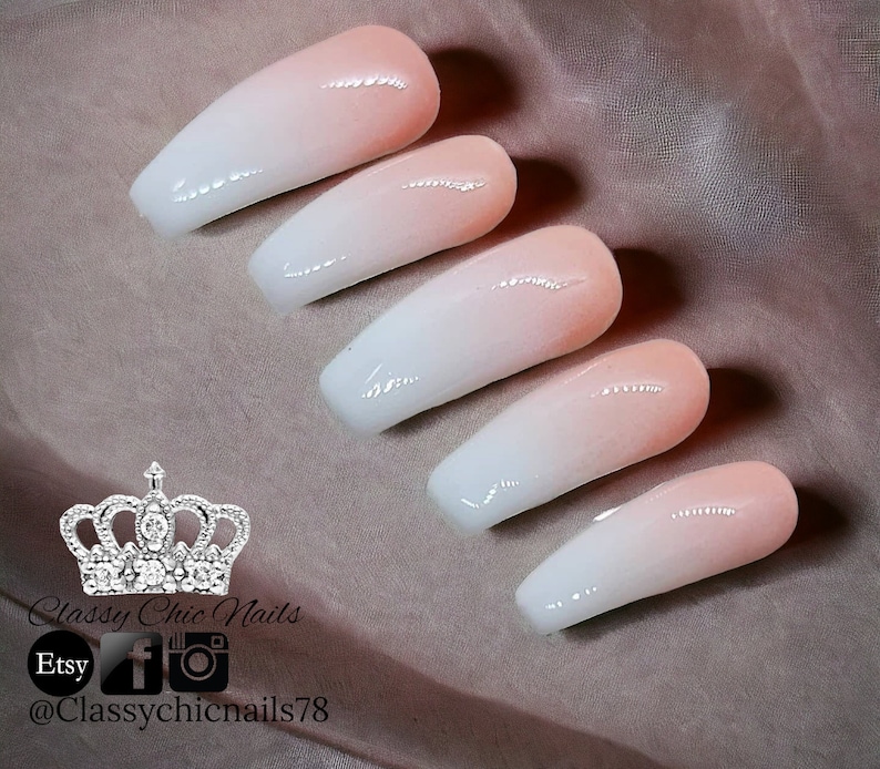 May include: Five press-on nails featuring a smooth ombre gradient transition from a soft peach at the cuticle to a crisp white at the tip. The nails have a glossy finish and a coffin shape. Text includes Classy Chic Nails, Etsy, and @Classychicnails78.