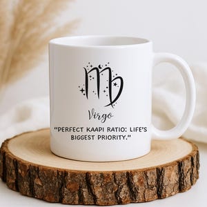 May include: White ceramic mug featuring the Virgo astrological symbol and the word "Virgo" in black script. The mug also includes the quote, "PERFECT KAAPI RATIO: LIFE'S BIGGEST PRIORITY." The mug is displayed on a wooden coaster.