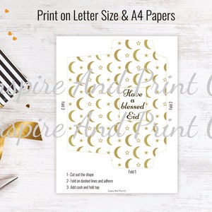 May include: Printable template for a gold and white envelope with a crescent moon and star pattern. The envelope has instructions to fold and add cash. The text on the envelope reads "Have a blessed Eid".