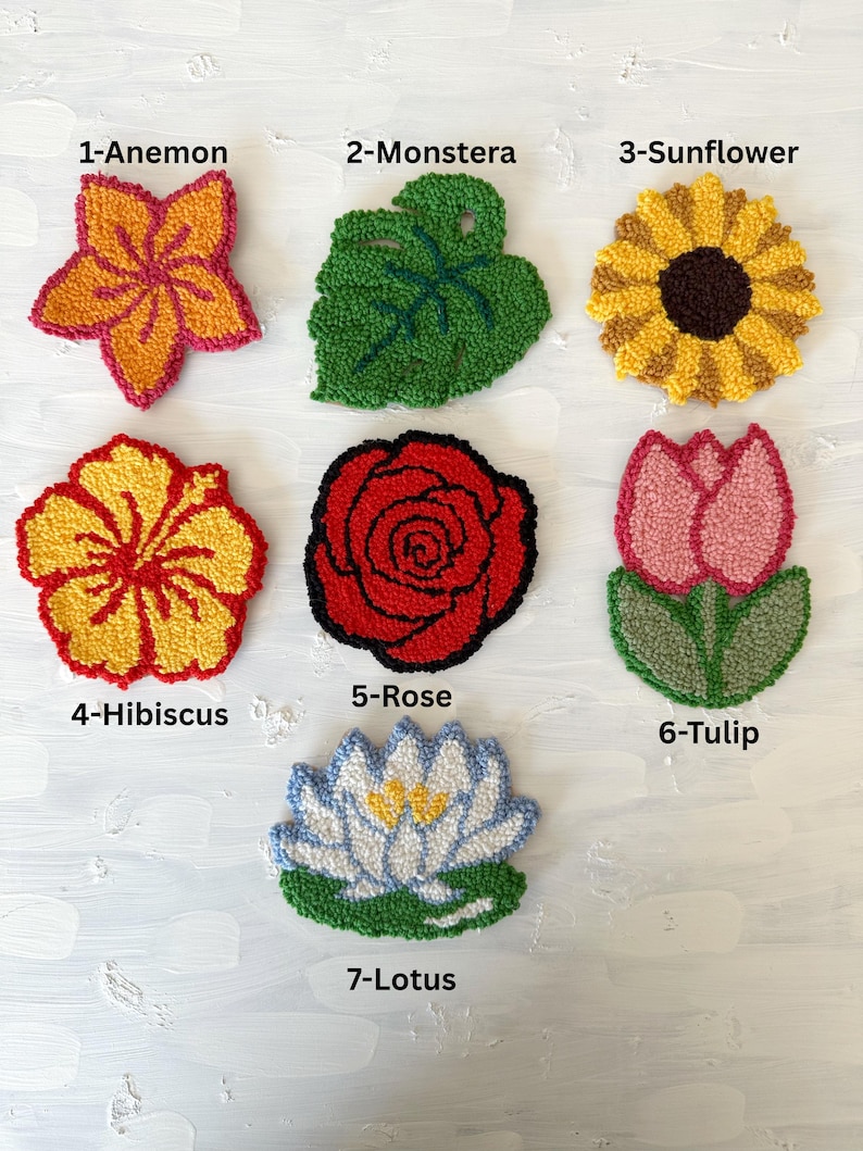 May include: A collection of seven colorful, handmade floral designs. The designs include an Anemone, Monstera leaf, Sunflower, Hibiscus, Rose, Tulip, and Lotus. Each design is labeled with a number and the flower's name.