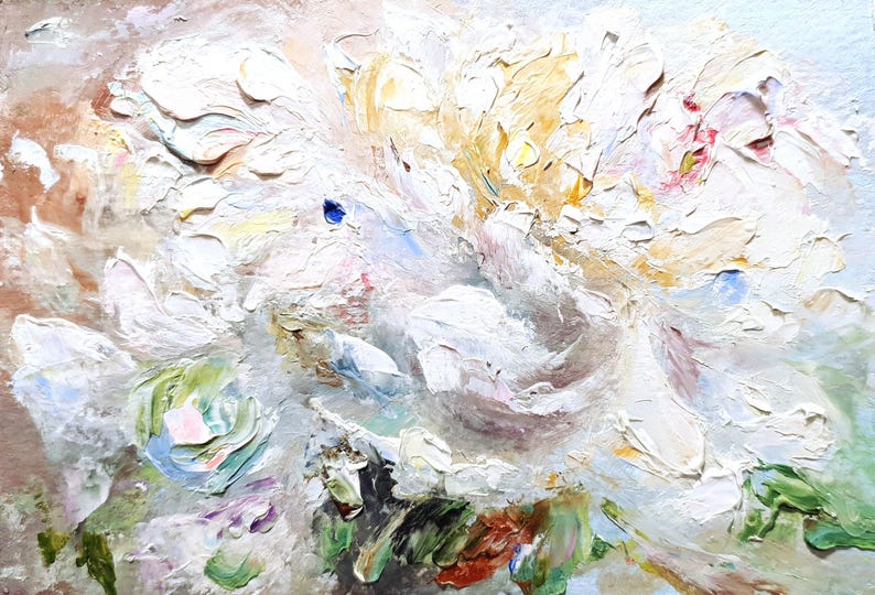 May include: Close-up of an abstract oil painting featuring a cluster of white flowers with textured brushstrokes. The artwork has accents of yellow, pink, green, and blue, creating a vibrant and detailed floral composition. The painting is on a neutral background.