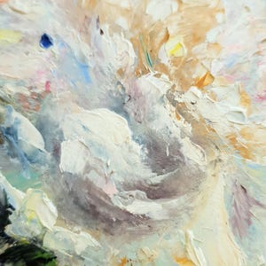 May include: Close-up of an oil painting featuring a textured floral arrangement. The artwork showcases thick brushstrokes in shades of white, cream, and light brown, with hints of blue, pink, and green. The painting is framed.