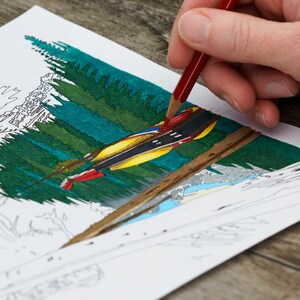 May include: A hand colors a drawing of a canoe in a forest with a red pencil. The canoe is yellow and red with black stripes. The forest is green and blue.
