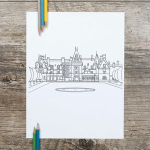 May include: A black and white line drawing of a large building with multiple turrets and windows, likely a historic landmark, on white paper. Colored pencils in blue, yellow, and green are arranged around the paper on a wooden surface.