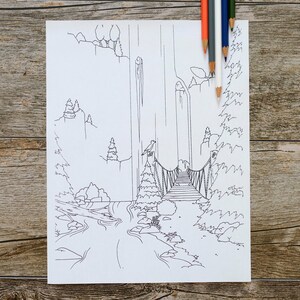 May include: A black and white line drawing of a landscape with a bridge, trees, and a waterfall. Colored pencils in orange, green, blue, and white are placed on the top right corner of the drawing. The drawing is on a white paper.