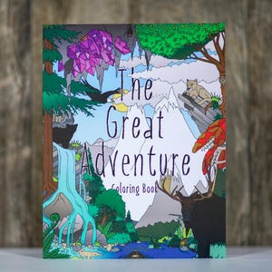 May include: A coloring book titled "The Great Adventure" with a colorful illustration of a mountain landscape, waterfall, and wildlife. The cover features a bear, moose, and other animals. The book is standing upright.