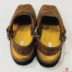 May include: A pair of brown leather sandals with a woven design on the upper and straps. The sandals have a yellow insole, black soles, and adjustable buckles. The sandals are handmade classics.