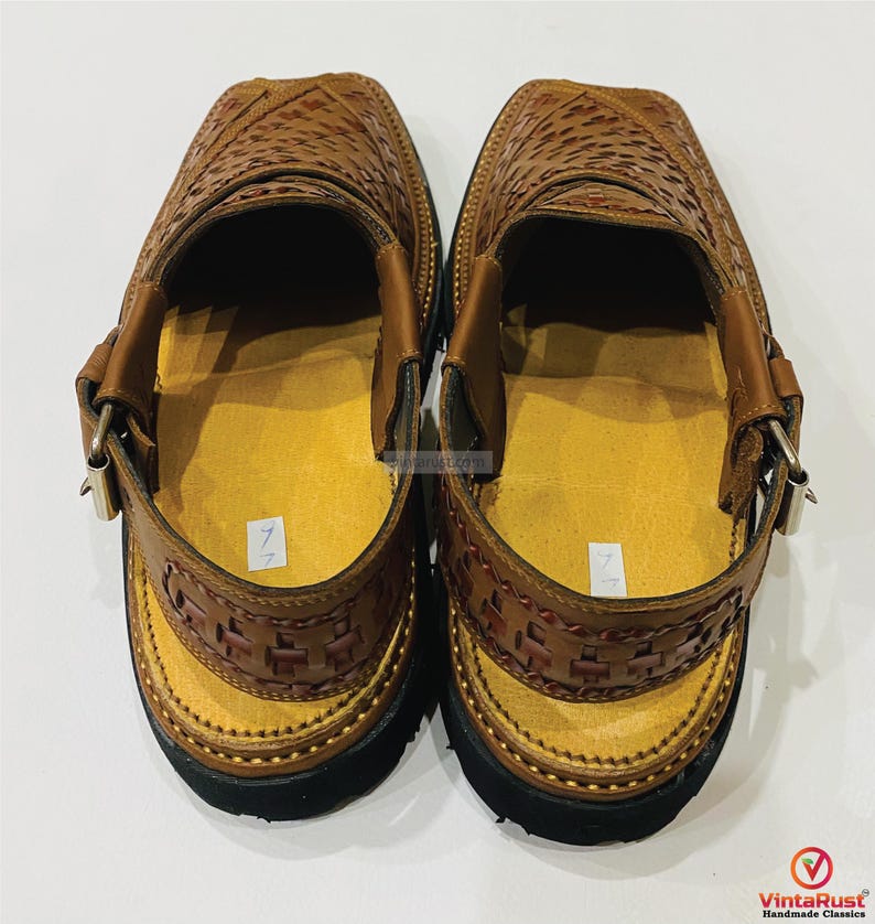 May include: A pair of brown leather sandals with a woven design on the upper and straps. The sandals have a yellow insole, black soles, and adjustable buckles. The sandals are handmade classics.