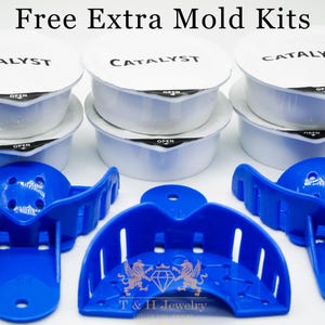 May include: Free extra mould kits for making custom jewellery. The kits include three white plastic containers labelled "Catalyst" and three blue plastic moulds.