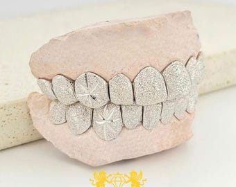 Individuell angefertigtes Grillz-Set mit silbernem Diamantstaub-Sternenmuster, mattierten Sternzahnkappen, schneller Versand und kostenloses Abdruckset inklusive