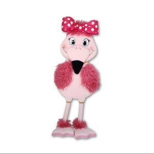 May include: A plush flamingo toy featuring a light pink body, dark pink faux fur wings, and long thin legs with webbed feet. The flamingo has a black beak, large cartoon eyes with long lashes, and a bright pink bow with white polka dots on its head.