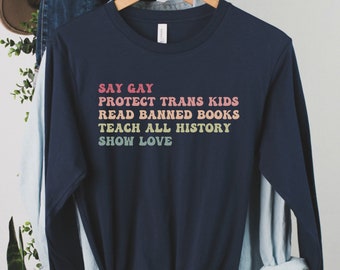 Camisa de manga larga "Digan que los gays protejan a los niños trans"; "Lean libros prohibidos; enseñen historia; muestren amor". Regalo de justicia social, derechos LGBTQ+, derechos humanos.