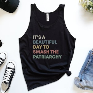 May include: Black tank top with the text "It's a beautiful day to smash the patriarchy" in colorful retro lettering.