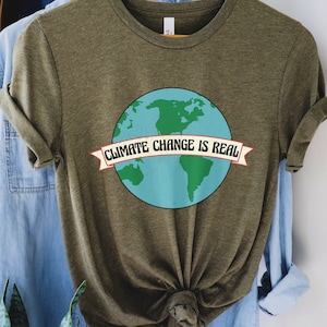 May include: A green t-shirt featuring a graphic of the Earth and the text "Climate Change is Real" in a banner.
