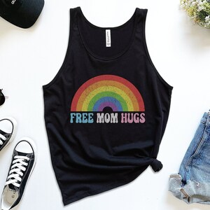 May include: Black tank top with a rainbow graphic and the text "FREE MOM HUGS".