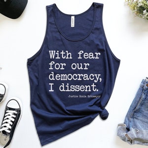 May include: A navy blue tank top with the text "With fear for our democracy, I dissent. -Justice Sonia Sotomayor" printed in white.