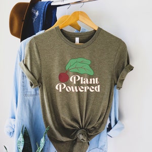 May include: A green t-shirt with a red beet and green leaves graphic and the text "Plant Powered" in a retro font.