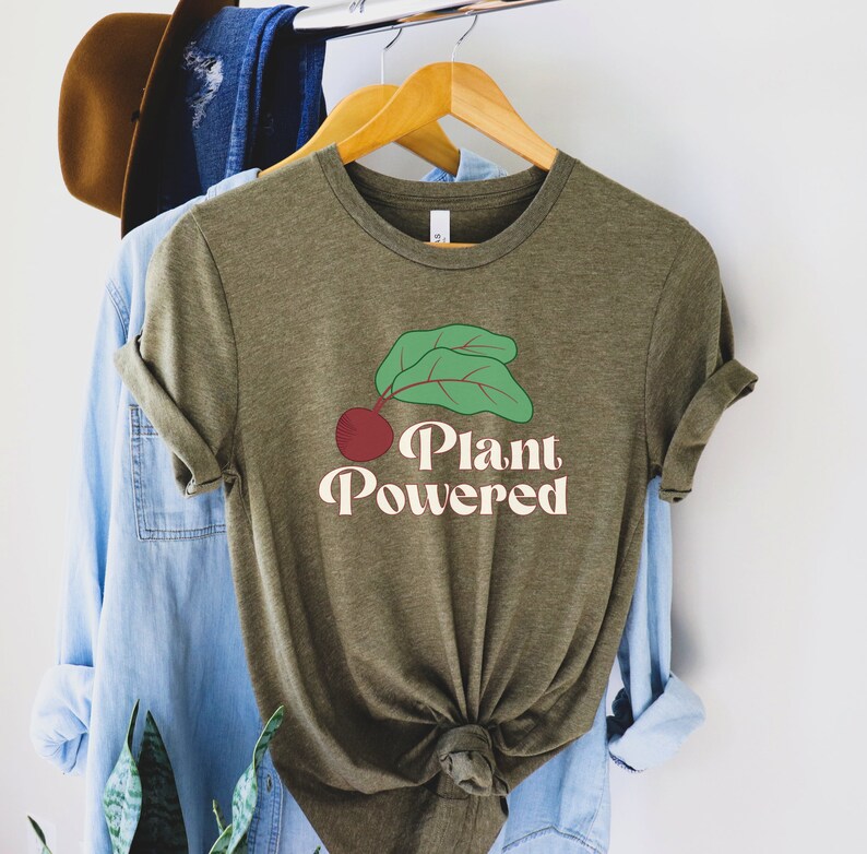 May include: A green t-shirt with a red beet and green leaves graphic and the text "Plant Powered" in a retro font.