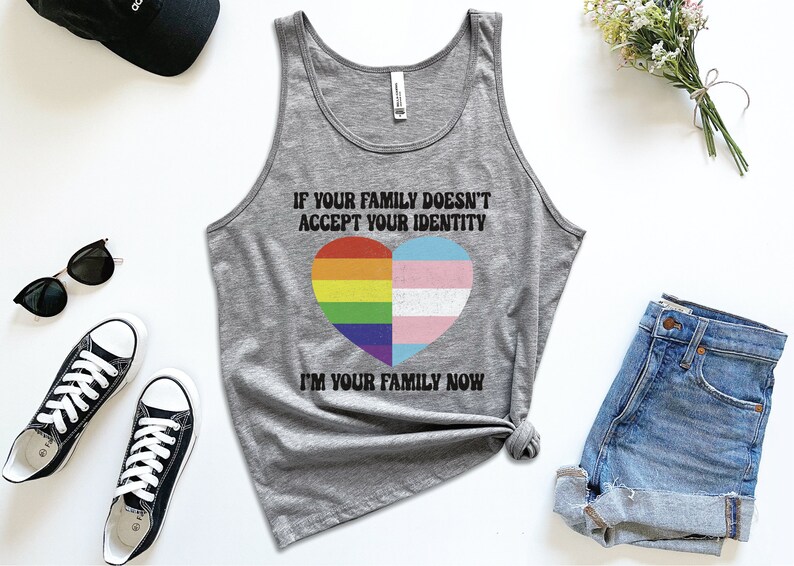 May include: Gray tank top with the text "If your family doesn't accept your identity I'm your family now" and a rainbow and transgender pride heart.