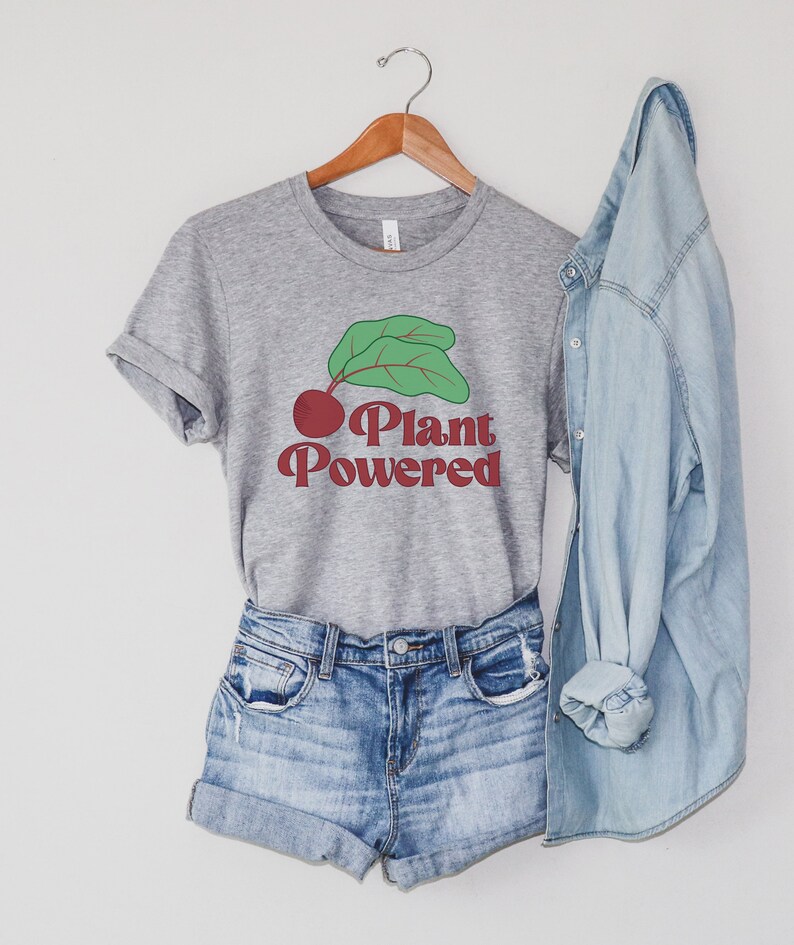 May include: A gray t-shirt with a red and green graphic of a beet with the text "Plant Powered" in red.