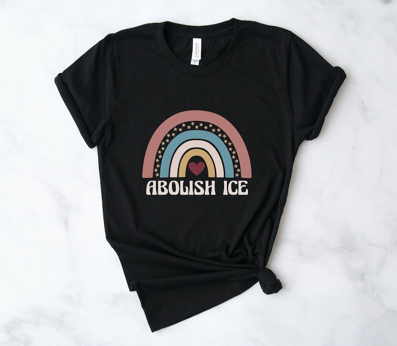 May include: Black t-shirt with a rainbow graphic and the text "Abolish ICE" in white letters.