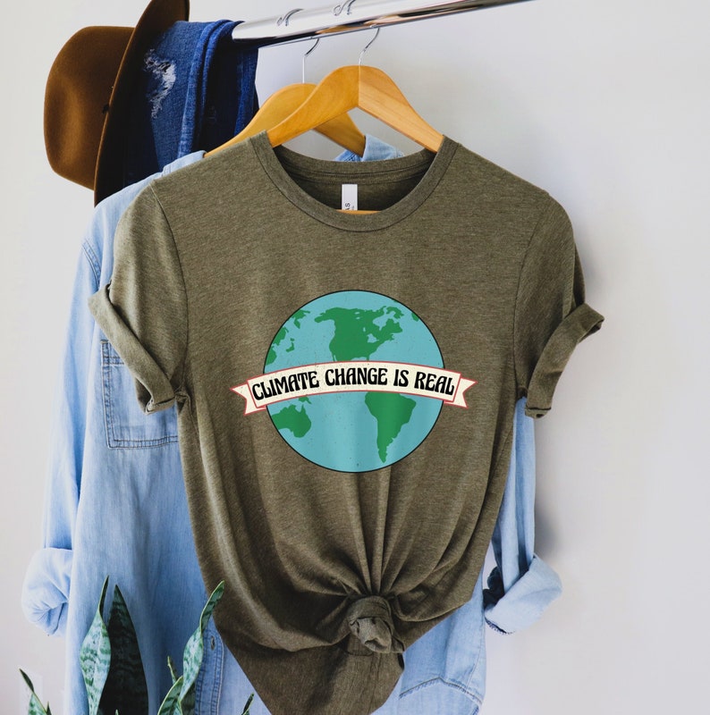 May include: A green t-shirt featuring a graphic of the Earth and the text "Climate Change is Real" in a banner.