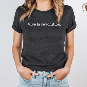 May include: A dark grey t-shirt with the text "Vive la révolution." printed in white.