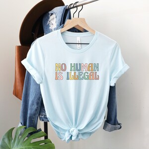 No Human is Illegal Shirt, Immigrant Rights TShirt, Social Justice Gift, Support Dreamers Tee, Antiracist Clothing, Human Rights Protest Top Heather Ice Blue