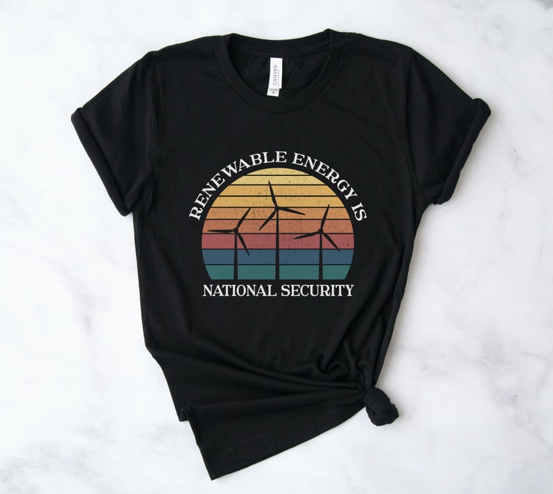 May include: Black t-shirt with a vintage-style graphic of wind turbines and a sunset. The text reads "Renewable Energy is National Security."