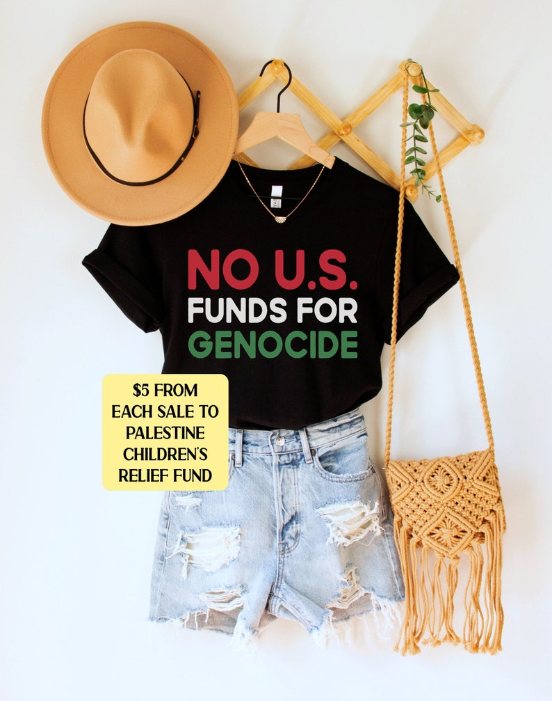 A black unisex crew neck short sleeve t-shirt with red, white, and green text that says "No U.S. funds for genocide"