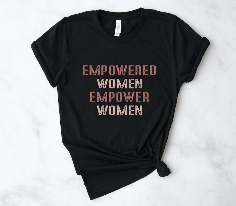 May include: Black t-shirt with the text "EMPOWERED WOMEN EMPOWER WOMEN" in a pink and white gradient.