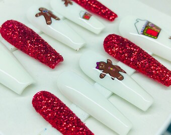 May include: Set of ten red glitter Christmas-themed press-on nails with gingerbread man and gingerbread house designs.