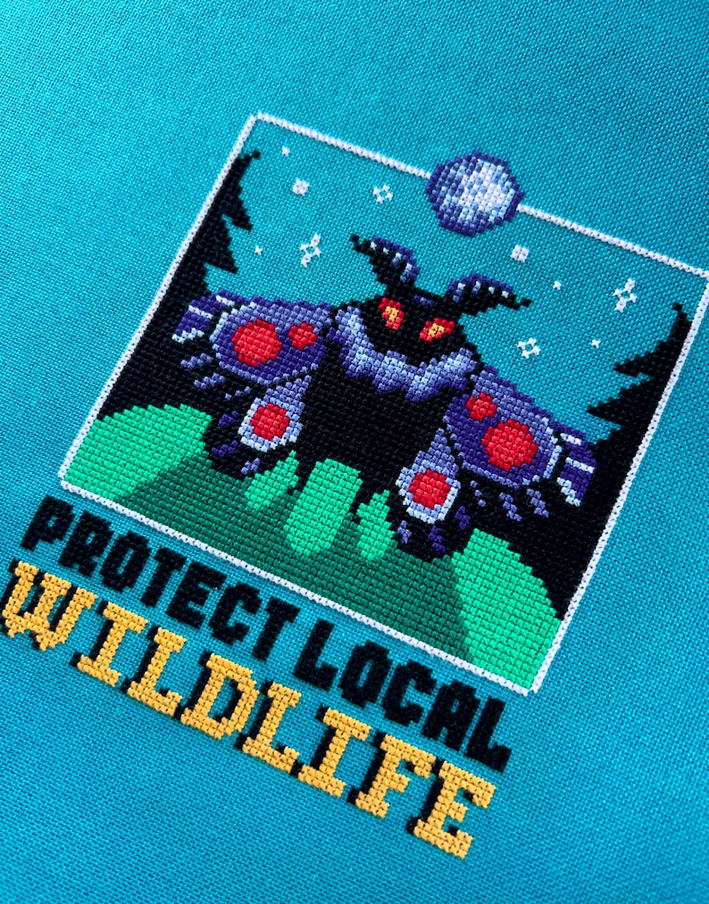 May include: A cross-stitch design featuring a black moth with red and purple accents, set against a teal background. The design includes the text "PROTECT LOCAL WILDLIFE" in yellow and black.