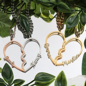 May include: Three gold, silver and rose gold necklaces with broken heart pendants. Each pendant has two names inscribed on it: "Grady" and "Honey", "Emma" and "Martin", and "Lucy" and "Honey".