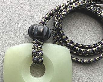 Hand carved jade pendant, "Concave Convex Trapezoid", Siberian nephrite with basalt  bead and hand braided silk