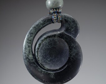 Hand carved jade pendant, "Dark Speckled Coriolis", Wyoming nephrite with nephrite bead and hand braided silk