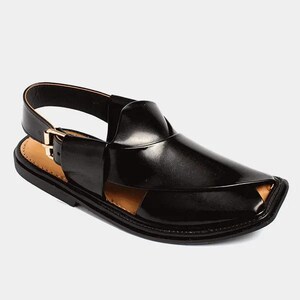 May include: Black leather sandal with a closed toe design and a strap around the ankle. The sandal features a gold-colored buckle and a contrasting tan insole. The shoe has a sleek, modern appearance.