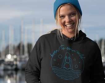 May include: A black hoodie with a blue graphic design that says "born to swim wild". The graphic features a stylised image of a person swimming in a circle with waves and bubbles.