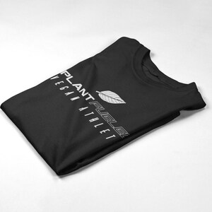 May include: A black t-shirt with a white leaf design and the text "PLANT FUEL" and "VEGAN ATHLETE" in white.