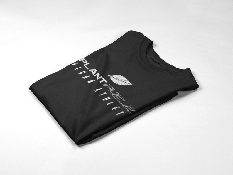May include: A black t-shirt with a white leaf design and the text "PLANT FUEL" and "VEGAN ATHLETE" in white.