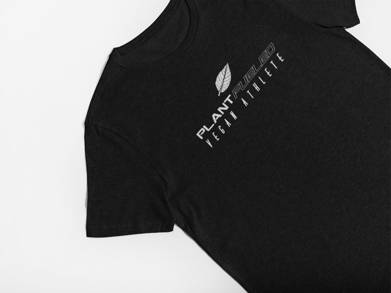 May include: Black t-shirt with a white leaf design and the text "PLANT-FUEL'D VEGAN ATHLETE" printed on the front.