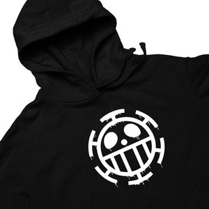 May include: Black hoodie with a white skull and crossbones design. The design is a stylized version of the Jolly Roger, a pirate flag.