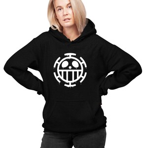May include: Black hoodie with a white skull and crossbones logo. The logo is a stylized version of the Jolly Roger, a pirate flag.