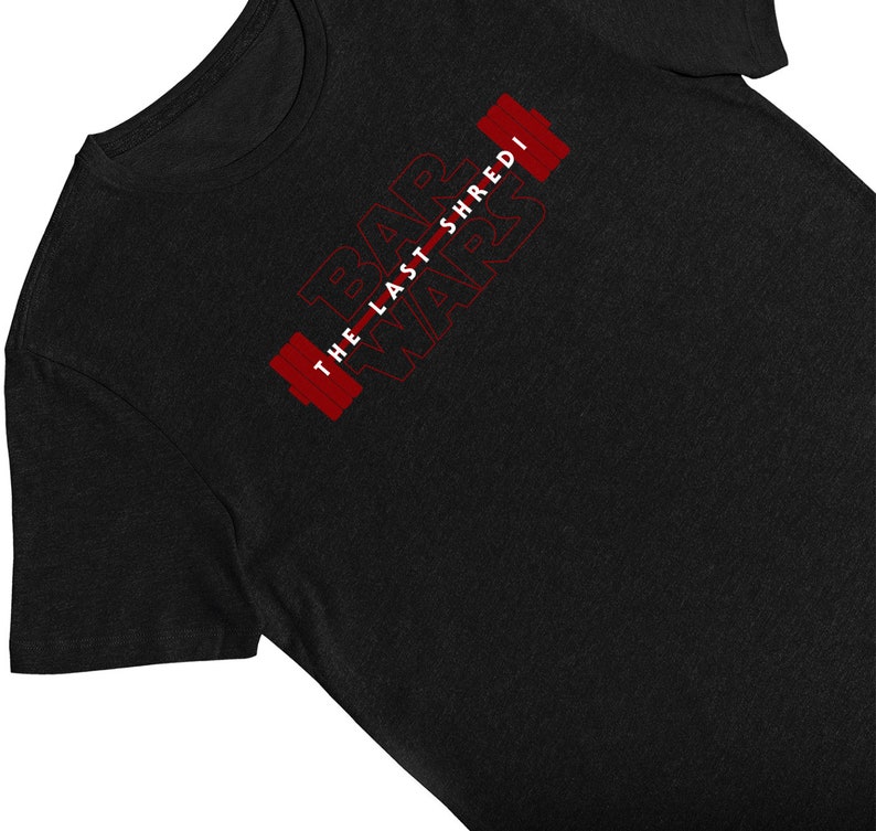 May include: Black t-shirt with the text "Bar Wars The Last Shredi" in red, featuring a barbell design. The shirt is made of a soft material and is suitable for workouts or casual wear.