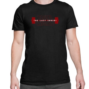 May include: Black t-shirt featuring the red text "BAR WARS THE LAST SHREDI" and a barbell graphic. The shirt is made of a soft material and has short sleeves.
