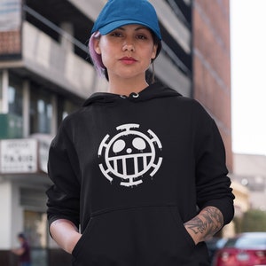 May include: A black hoodie with a white skull and crossbones design. The design is a symbol from the popular anime series One Piece.