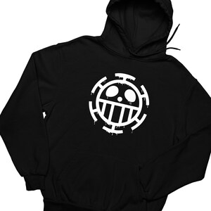 May include: Black hooded sweatshirt with a white graphic of the One Piece anime character, Trafalgar D. Water Law's Jolly Roger, the Heart Pirates symbol. The symbol is a skull with a crossbones and a dripping effect.